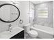 Updated bathroom with marble tile shower and modern vanity at 1204 Dartmouth Dr, Bradenton, FL 34207