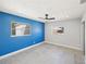 Bedroom with gray and blue walls, ceiling fan and tile floors at 1204 Dartmouth Dr, Bradenton, FL 34207