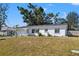 White single story home with a spacious lawn and mature trees at 1204 Dartmouth Dr, Bradenton, FL 34207