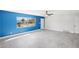 Bright living room with large window and blue accent wall at 1204 Dartmouth Dr, Bradenton, FL 34207