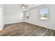 Spacious bedroom with wood-look flooring and two windows at 12332 Prairie Valley Ln, Riverview, FL 33579