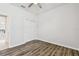 Bedroom with wood-look floors and double door closet at 12332 Prairie Valley Ln, Riverview, FL 33579
