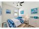 Virtually staged bedroom with wood-look floors, ceiling fan, and dresser at 12332 Prairie Valley Ln, Riverview, FL 33579