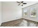 Empty bedroom with wood-look flooring and two large windows at 12332 Prairie Valley Ln, Riverview, FL 33579