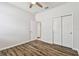Bedroom with wood-look floors, ceiling fan, and closet at 12332 Prairie Valley Ln, Riverview, FL 33579