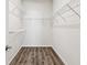Large walk-in closet with wire shelving and wood flooring at 12332 Prairie Valley Ln, Riverview, FL 33579