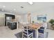 Kitchen and dining area with an island, wood table, and stainless steel appliances at 12332 Prairie Valley Ln, Riverview, FL 33579