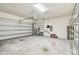 Attached garage with shelving and space for lawn equipment at 12332 Prairie Valley Ln, Riverview, FL 33579