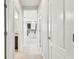 Hallway with tile floors and views into kitchen and bedrooms at 12332 Prairie Valley Ln, Riverview, FL 33579