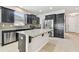 Kitchen with island, stainless steel appliances, and dark cabinets at 12332 Prairie Valley Ln, Riverview, FL 33579
