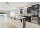 Open kitchen with island, stainless steel appliances, and granite countertops at 12332 Prairie Valley Ln, Riverview, FL 33579