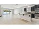 Open kitchen with island, stainless steel appliances, and granite countertops at 12332 Prairie Valley Ln, Riverview, FL 33579