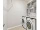 Laundry room with washer, dryer, and decorative wall shelving at 12332 Prairie Valley Ln, Riverview, FL 33579