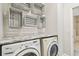 Laundry room with stacked washer and dryer, and decorative storage at 12332 Prairie Valley Ln, Riverview, FL 33579
