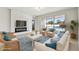 Bright living room with fireplace and sliding doors leading to the pool at 12332 Prairie Valley Ln, Riverview, FL 33579