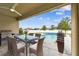 Covered patio with dining set overlooking a refreshing pool at 12332 Prairie Valley Ln, Riverview, FL 33579