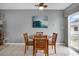 Dining area with wood table and chairs, adjacent to the kitchen at 12400 Park Blvd # 206, Seminole, FL 33772