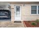 Front door of a light-colored, single-story home with carport at 12400 Park Blvd # 206, Seminole, FL 33772
