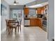 Kitchen with wood cabinets, stainless steel appliances, and tiled floor at 12400 Park Blvd # 206, Seminole, FL 33772