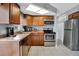 Bright kitchen featuring stainless steel appliances and wood cabinets at 12400 Park Blvd # 206, Seminole, FL 33772