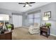 Living room with gray walls, carpeted floors, and a ceiling fan at 12400 Park Blvd # 206, Seminole, FL 33772