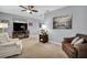 Living room with gray walls, carpeted floors, and comfy seating at 12400 Park Blvd # 206, Seminole, FL 33772