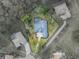 Bird's-eye view of a house with pool, located in a residential neighborhood at 12632 Oak Hollow Ct, Dade City, FL 33525