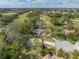 An aerial view showcasing a house on a golf course community at 12632 Oak Hollow Ct, Dade City, FL 33525
