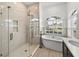 Bathroom with large walk-in shower, freestanding tub, and a window at 12632 Oak Hollow Ct, Dade City, FL 33525