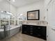 Elegant bathroom with soaking tub, double vanity, and large mirror at 12632 Oak Hollow Ct, Dade City, FL 33525