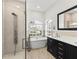 Spa-like bathroom with soaking tub, walk-in shower, and dual vanity at 12632 Oak Hollow Ct, Dade City, FL 33525