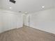 Spacious bedroom with wood-look floors and double doors at 12632 Oak Hollow Ct, Dade City, FL 33525