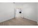 Bright bedroom with wood-look floors and access to another room at 12632 Oak Hollow Ct, Dade City, FL 33525