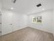 Well-lit bedroom with wood-look floors and an exterior door at 12632 Oak Hollow Ct, Dade City, FL 33525