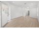 Bright bedroom with sliding glass doors, wood-look floors, and access to another room at 12632 Oak Hollow Ct, Dade City, FL 33525