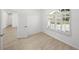 Spacious bedroom with wood-look floors and access to another room at 12632 Oak Hollow Ct, Dade City, FL 33525