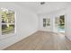 Bedroom with sliding glass doors opening to a private patio and pool views at 12632 Oak Hollow Ct, Dade City, FL 33525