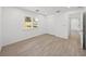 Bright bedroom with wood-look floors and window shutters at 12632 Oak Hollow Ct, Dade City, FL 33525