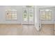 Bright entryway with double doors and wood-look flooring at 12632 Oak Hollow Ct, Dade City, FL 33525