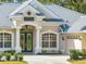 Home with double front doors and a decorative archway at 12632 Oak Hollow Ct, Dade City, FL 33525