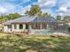 Single-story house with a large pool and screened enclosure in the backyard at 12632 Oak Hollow Ct, Dade City, FL 33525