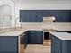 Modern kitchen with stainless steel appliances and blue cabinetry at 12632 Oak Hollow Ct, Dade City, FL 33525
