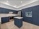 Stylish kitchen, blue cabinetry, stainless steel appliances at 12632 Oak Hollow Ct, Dade City, FL 33525