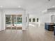 Open concept living area with pool view and hardwood floors at 12632 Oak Hollow Ct, Dade City, FL 33525
