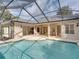 Screened pool and patio with a view at 12632 Oak Hollow Ct, Dade City, FL 33525