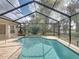 Inviting screened pool area with spacious patio and tranquil golf course views at 12632 Oak Hollow Ct, Dade City, FL 33525