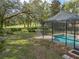 Relaxing screened pool and patio overlooking a lush golf course at 12632 Oak Hollow Ct, Dade City, FL 33525