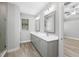 Double vanity bathroom with gray cabinets and quartz countertops at 13458 Haflinger Way, Hudson, FL 34667