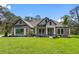 Attractive one-story home with stone accents and a landscaped lawn at 13458 Haflinger Way, Hudson, FL 34667