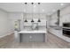 Modern kitchen with white cabinets, quartz island, and stainless steel appliances at 13458 Haflinger Way, Hudson, FL 34667